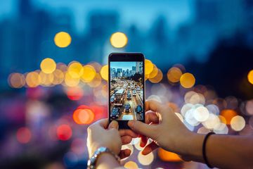 Woman capturing the busy traffic with smartphone