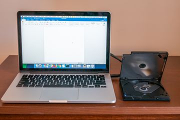 Laptop with an external desktop Blu-ray drive.