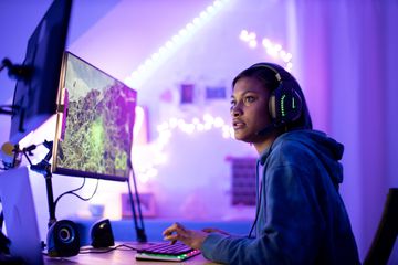 A young gamer with a gaming monitor on a monitor arm.