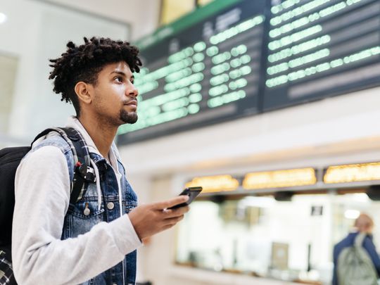 Person at the airport with a smartphone.