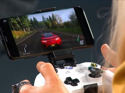 A person playing a game on a smartphone with an Xbox controller attached to it