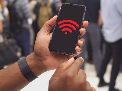 A person holding a phone displaying the Wi-Fi symbol in red