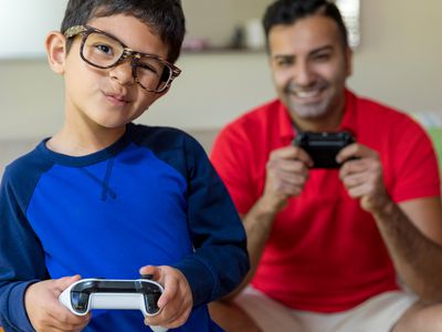 Boy and father playing Xbox One video games